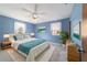 Relaxing bedroom with light blue walls and a king-size bed at 3261 Se 32Nd St, Ocala, FL 34471