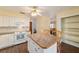 Spacious kitchen with white cabinets and an island at 3261 Se 32Nd St, Ocala, FL 34471