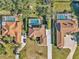 Aerial view of three homes with pools and lush landscaping at 407 Soft Shadow Ln, Debary, FL 32713