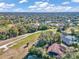 Aerial view of golf course, pond, and neighborhood at 407 Soft Shadow Ln, Debary, FL 32713