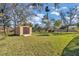 Large backyard with shed and mature trees at 407 Soft Shadow Ln, Debary, FL 32713