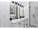 Bright bathroom vanity features dual sinks, large mirrors, and storage at 407 Soft Shadow Ln, Debary, FL 32713