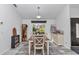 Bright dining area with a large window, pendant lighting, and stylish decor on a gray and white rug at 407 Soft Shadow Ln, Debary, FL 32713