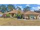 Brick house with brown roof, landscaping, and a spacious lawn at 407 Soft Shadow Ln, Debary, FL 32713