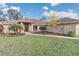 Attractive brick home showcasing lush front yard landscaping, a stone walkway, and a healthy green lawn at 407 Soft Shadow Ln, Debary, FL 32713