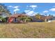 Brick home with palm trees and well-manicured lawn at 407 Soft Shadow Ln, Debary, FL 32713