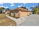 Attached garage with tan door and brick exterior at 407 Soft Shadow Ln, Debary, FL 32713