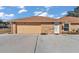 Tan garage door and white door in brick building at 407 Soft Shadow Ln, Debary, FL 32713