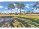 View of a lush green golf course with tall trees at 407 Soft Shadow Ln, Debary, FL 32713