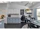 Kitchen with office nook featuring modern gray cabinets and stone backsplash at 407 Soft Shadow Ln, Debary, FL 32713