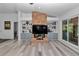 Bright living space with a modern brick fireplace, floating tv, display shelves, and stylish flooring at 407 Soft Shadow Ln, Debary, FL 32713