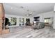 Open living room featuring gray sectional sofa and wood-look floors at 407 Soft Shadow Ln, Debary, FL 32713