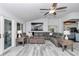 Comfortable living room showcasing a sectional sofa, modern decor, and ample natural light from glass doors at 407 Soft Shadow Ln, Debary, FL 32713