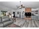 Cozy living room featuring a brick fireplace, built-in shelving, recessed lighting, and neutral colors at 407 Soft Shadow Ln, Debary, FL 32713