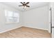 Bright bedroom with wood-look floors and a window with sheer curtains at 9664 Sw 76Th Lane Rd, Ocala, FL 34481