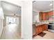 Open kitchen with stainless steel appliances and wood cabinets. View of living room at 9664 Sw 76Th Lane Rd, Ocala, FL 34481