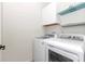 Laundry room with washer, dryer, cabinets, and shelving at 9664 Sw 76Th Lane Rd, Ocala, FL 34481