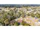 Aerial view of neighborhood with green tree coverage and a house with blue pool at 2922 Se 38Th Pl, Ocala, FL 34480