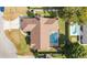 Aerial view of a brown roof home with pool and screen enclosure plus long driveway at 2922 Se 38Th Pl, Ocala, FL 34480