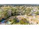 Aerial view of a home featuring a screened-in pool and lush green landscaping at 2922 Se 38Th Pl, Ocala, FL 34480