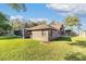 Backyard of brick home featuring a screened in patio and green lawn at 2922 Se 38Th Pl, Ocala, FL 34480