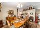 Bright dining room with hardwood table, vintage furnishings, and view to other rooms at 2922 Se 38Th Pl, Ocala, FL 34480