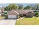 Beautiful aerial view of a charming brick home with lush landscaping and an attached garage at 2922 Se 38Th Pl, Ocala, FL 34480