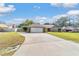 Charming single-story brick home featuring a two-car garage and a long concrete driveway at 2922 Se 38Th Pl, Ocala, FL 34480