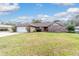 Charming single-story brick home featuring an attached two-car garage and a well-manicured lawn at 2922 Se 38Th Pl, Ocala, FL 34480