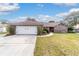 Charming single-story brick home featuring an attached two-car garage and a well-manicured lawn at 2922 Se 38Th Pl, Ocala, FL 34480