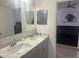 Double vanity bathroom with granite countertops at 45 Orchid Ct, Kissimmee, FL 34759