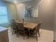 Bright dining room with wood table and four brown chairs at 45 Orchid Ct, Kissimmee, FL 34759