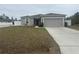 Single-story home with gray siding and two-car garage at 45 Orchid Ct, Kissimmee, FL 34759