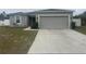 House exterior with gray siding and a two-car garage at 45 Orchid Ct, Kissimmee, FL 34759