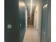 Clean hallway with teal and gray walls, tile flooring at 45 Orchid Ct, Kissimmee, FL 34759