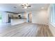 Open-concept living room with a view of the modern kitchen and stainless steel appliances at 11 Locust Terrace Way, Ocala, FL 34472