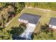 Aerial view of home with a driveway, spacious lawn, and a private wooded backyard at 11 Locust Terrace Way, Ocala, FL 34472