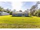 Expansive backyard with lush green grass, two homes, and bordered by mature trees at 11 Locust Terrace Way, Ocala, FL 34472