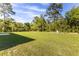 Expansive backyard featuring a green lawn bordered by mature trees at 11 Locust Terrace Way, Ocala, FL 34472