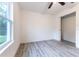 Bright bedroom featuring wood-look flooring, closet, and a window for ample natural light at 11 Locust Terrace Way, Ocala, FL 34472