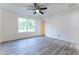 Spacious bedroom with wood-look floors, a ceiling fan, a window, and neutral paint at 11 Locust Terrace Way, Ocala, FL 34472