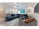 A well-furnished living room featuring neutral walls, a ceiling fan, and wood-look floors at 11 Locust Terrace Way, Ocala, FL 34472