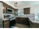 Modern kitchen featuring stainless steel appliances, granite countertops, and dark wood cabinets at 2060 Se 39Th St, Ocala, FL 34480