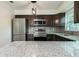 Modern kitchen featuring stainless steel appliances, granite countertops, and dark wood cabinets at 2060 Se 39Th St, Ocala, FL 34480