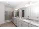 Elegant bathroom with double vanity, granite countertops, and a glass-enclosed shower at 4358 Nw 57Th Ave, Ocala, FL 34482