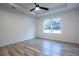 Bright bedroom featuring wood-look floors, a ceiling fan, and a window view at 741 Ne 130Th Ter, Silver Springs, FL 34488