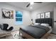 A modern bedroom features light wood flooring and a grey cushioned bed frame at 741 Ne 130Th Ter, Silver Springs, FL 34488