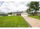 Attractive single-Gathering home with a well-kept lawn and concrete driveway leading to a 2-car garage at 741 Ne 130Th Ter, Silver Springs, FL 34488