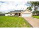 Charming single-story home with a well-manicured lawn, stone accents, and an attached two-car garage at 741 Ne 130Th Ter, Silver Springs, FL 34488