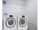 A modern laundry room features a wire rack and modern washer and dryer units at 741 Ne 130Th Ter, Silver Springs, FL 34488